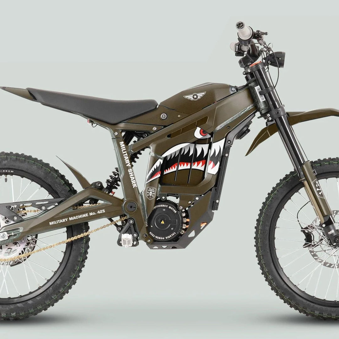 Military-styled off-road electric motorcycle with olive drab green paint, shark-mouth decal, and marked MILITARY MACHINE No. 425, showcasing Talaria Sting MX3 MX4 Graphics Kit MILITARY SHARK Brown.