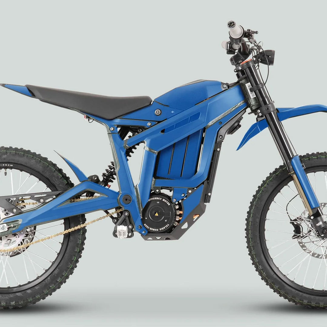 Side-profile of Talaria Sting MX3 MX4 Graphics Kit SOLID COLOR BLUE on an e-dirt bike, featuring integrated battery, mid-mounted motor, and knobby tires.