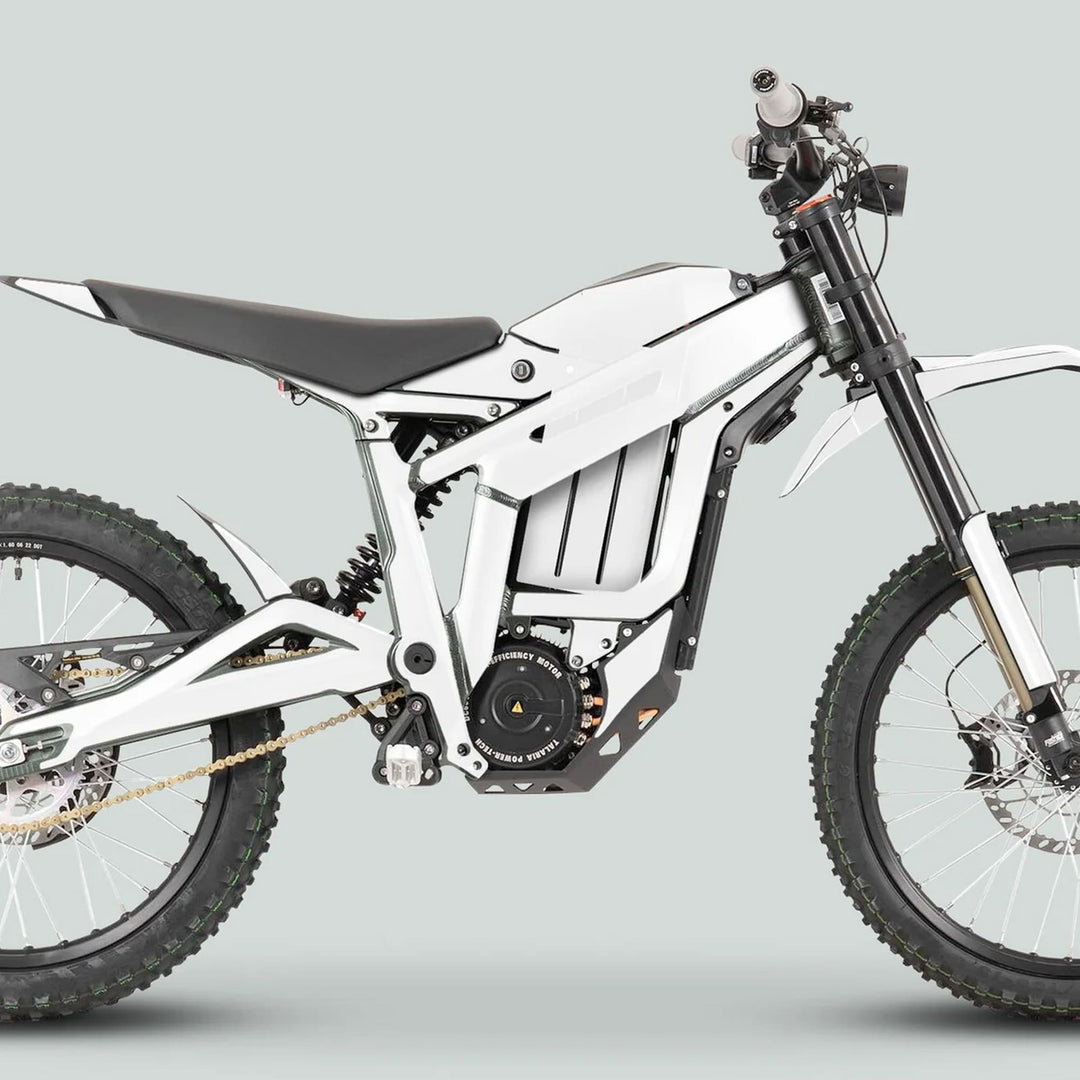Side-view of a white Talaria Sting MX3 MX4 dirt bike featuring knobby tires and central housing for graphics kit showcasing a sleek solid color design.