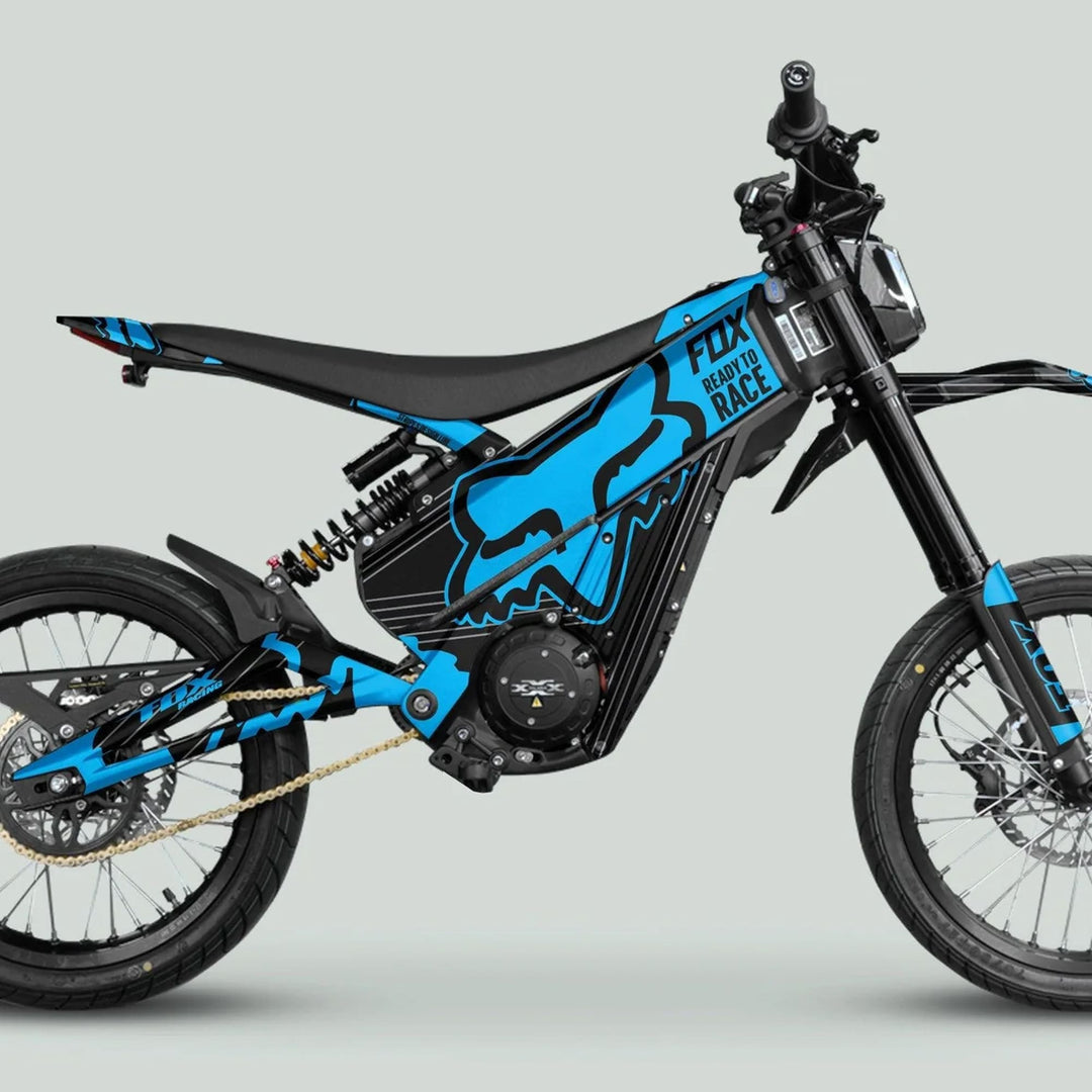 Side view of Talaria XXX Graphics Kit FOX STRIPES Black Cyan on an electric dirt-bike, showcasing bold decals on frame, enhancing style and protection.