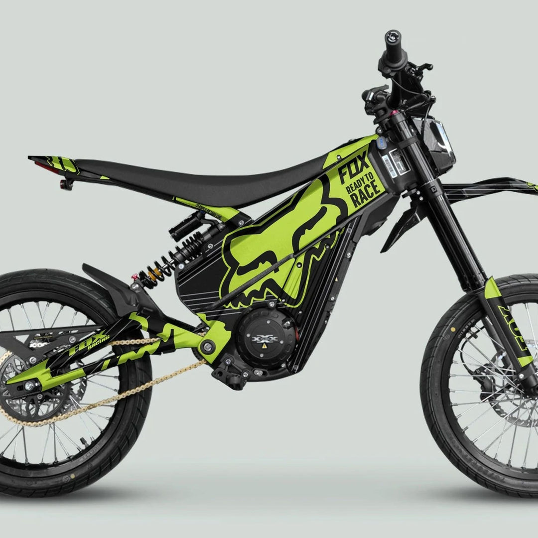 Talaria XXX Graphics Kit FOX STRIPES in black and green on an e-dirt bike, highlighting motocross-inspired frame and spoked wheels with disc brakes.