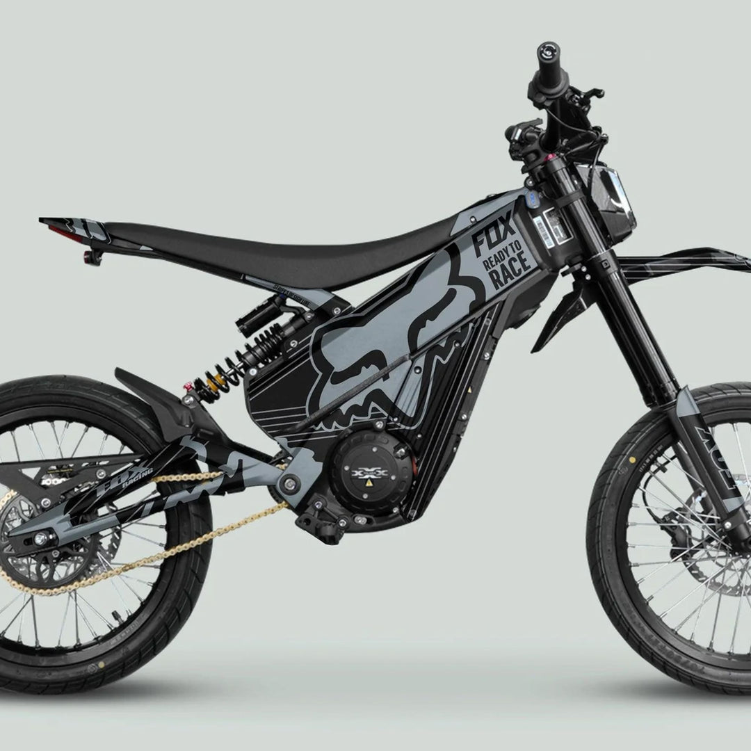 Talaria XXX Graphics Kit FOX STRIPES Black Grey adorns an electric dirt bike with FOX Racing graphics, enhancing style with durable, weather-resistant decals for Talaria models.