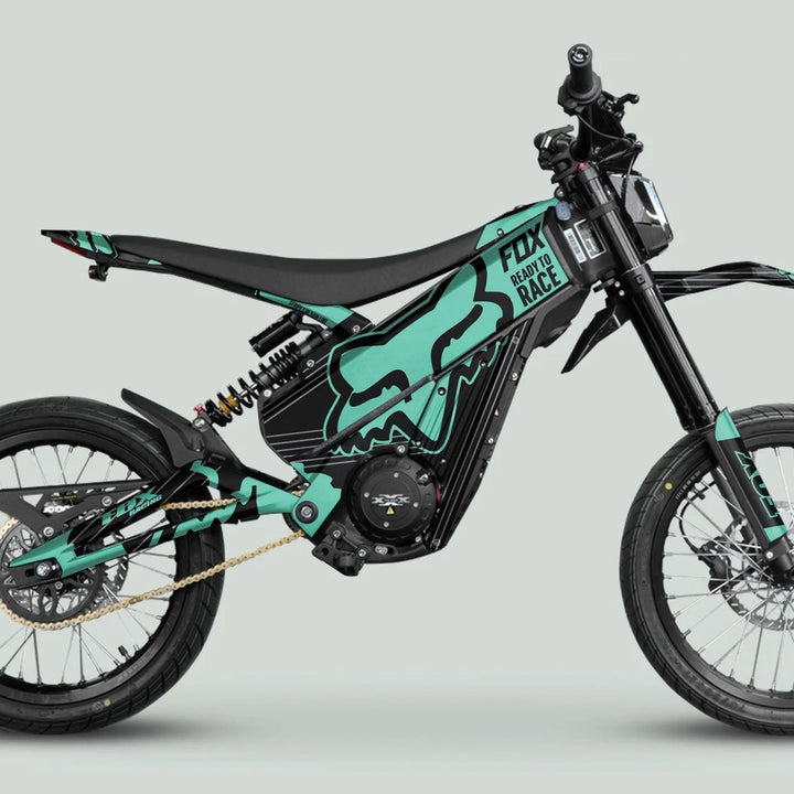 Talaria XXX Graphics Kit FOX STRIPES Black Mint on a black e-dirt bike, showcasing sleek design and durability for enhanced aesthetics and protection.