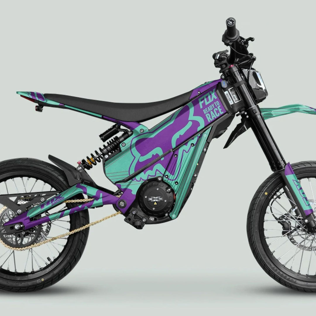 Talaria XXX Graphics Kit FOX STRIPES Purple Mint on a sleek electric dirt bike, showcasing vibrant teal and purple panels with durable, eye-catching design.