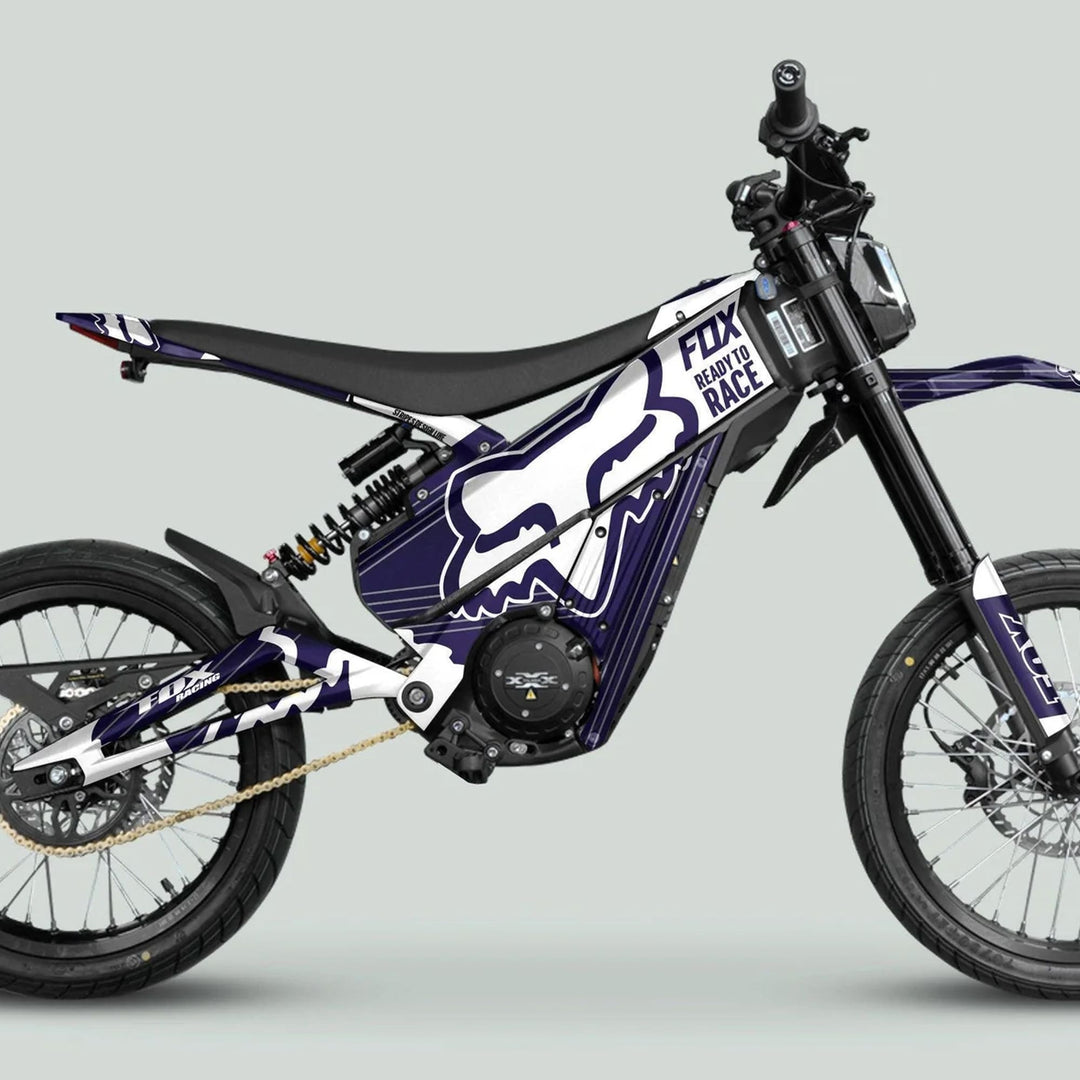 Talaria XXX Graphics Kit FOX STRIPES Navy White on an off-road electric motorcycle, showcasing a striking navy and white design with protective features.