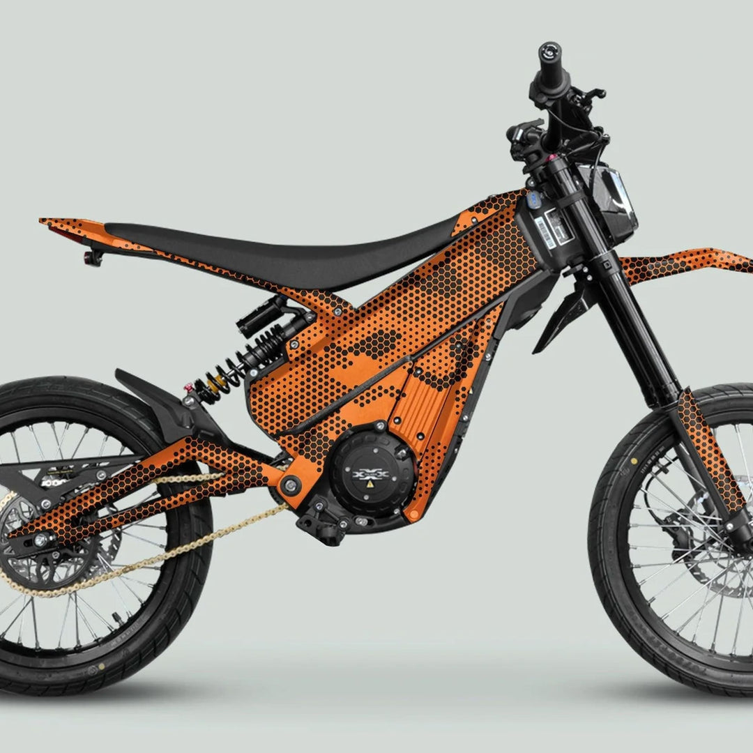 Side-profile of the Talaria XXX Graphics Kit HEXOCAM Orange on an e-dirt bike, showcasing its honeycomb-patterned frame and sleek black saddle.