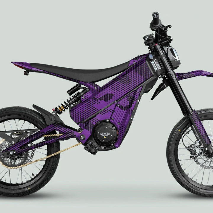 Side-view of Talaria XXX Graphics Kit HEXOCAM Purple on an e-dirt bike, featuring high-tensile frame, mono-shock suspension, and off-road tyres.